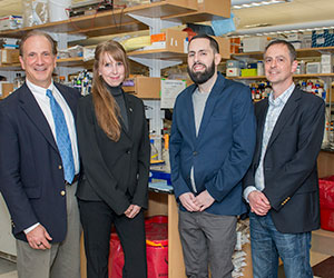 From left, Fibrolamellar Cancer Foundation executive director John Hopper, founding member Alicia Sternenberger, patient Patrick McDonough and Mass General cancer researcher Nabeel Bardeesy, PhD, in his laboratory.