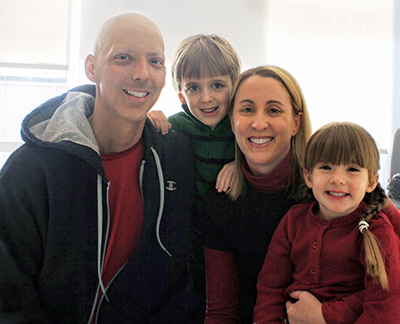Brian and Kristen Thibodeau and their two children pictured at the Mass General Cancer Center.