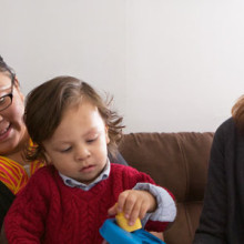 Tania Soares (right), an infant/parent specialist at MGH Chelsea, visits with Deisy Ortiz and her son, Danny.