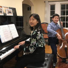From their living room, Elizabeth and Ethan Qian-Tsuchida play classical duets and post them on their fundraising page.