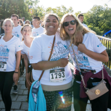 Mass General community members wearing their Mass General shirts smile for the camera after running the Everyday Amazing Race