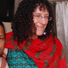 AnneKathryn Goodman, MD (center), works with women in Bangladesh to increase screening for cervical cancer.