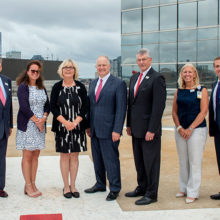 Leaders from John Hancock and Mass General gather at the Emergency Department helipad to celebrate their ongoing partnership. (The names of those photographed appear at end of story.)