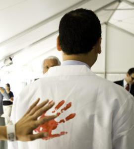 Miguel Rivera, MD, receives a handprint from a patient during the Hyundai Hope on Wheels Handprint Ceremony for research on childhood cancer.