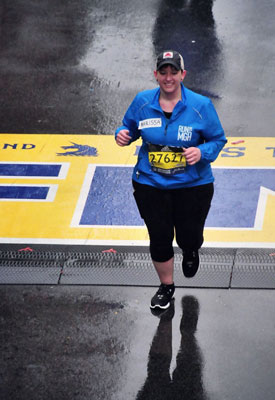 Marissa Capua crossing the Boston Marathon® finish line in 2018.