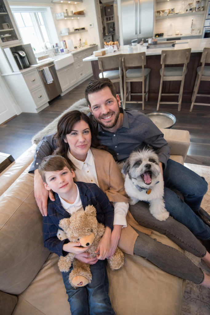 At home in Milton, Massachusetts, Caitlin, Rich and Brice snuggle with dog, YZ.