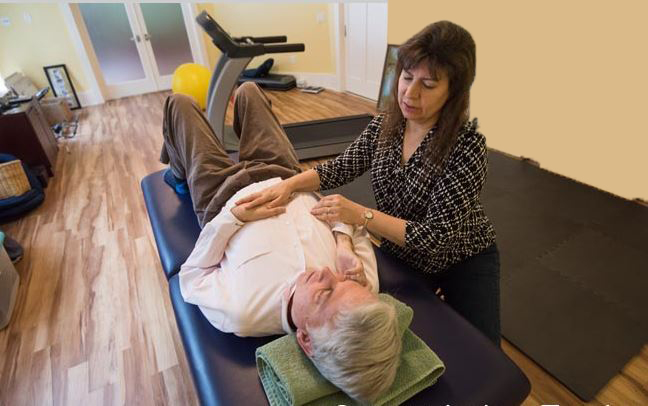 At home, Jane helps Stephen with physical therapy stretches.