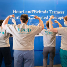 Cancer Center clinicians showed off t-shirts for the Viral Providers of the Day (VPOD) team which worked to evaluate patients for COVID-19 symptoms.