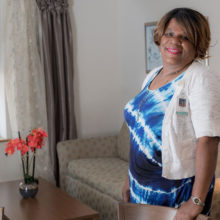 Sharon Scott, the Mass General manager of lodging at Beacon House, shows off a room renovated through corporate generosity.
