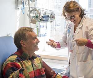Clinical Research: Roberta Dee, RN, prepares patient Michael Bamber for an infusion of a new drug in a clinical trail TCRC.