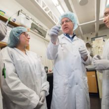 Guillermo (Gary) J. Tearney, MD, PhD and engineering technicians in his lab hold the swallowable capsule he developed to diagnose problems in the gastrointestinal tract.