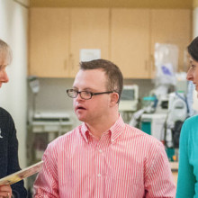 Ben Majewski (center), who has Down syndrome, is a resource specialist with the Down Syndrome Adolescent, & Yound Adult Clinic. He is pictured with social worker Helen Weiner, MS, LICSW, (left) and Christianne Sharr, program coordinator.