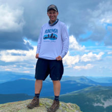Michael York at the summit of South Twin Mountain in New Hampshire (4,902ft) during a 33-mile hike, with Mount Washington in the background.