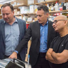 Mass General brain disease researchers (from the left) Stephen Haggarty, PhD, Roy Perlis, MD, and Rakesh Karmacharya, MD, PhD, confer about a cell model.