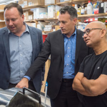 Mass General brain disease researchers (from the left) Stephen Haggarty, PhD, Roy Perlis, MD, and Rakesh Karmacharya, MD, PhD, confer about a cell model.