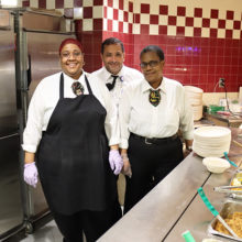 Mass General Eat Street Café staffers (from left) Seandel Grant, Jorge Santana and Paula Brathwaite leave excess food in the warmer to be put aside at closing for Food for Free.