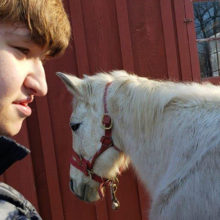 Since receiving care for a rare genetic disorder and enrolling in a private school, Jesse Simon has been deeply engaged in activities that range from classroom work to feeding horses in the school barn. (Photo courtesy of Monica Simon)