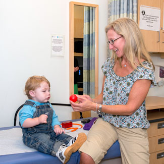 With therapists, Dr. Kerzner tracks the development of children like Declan.