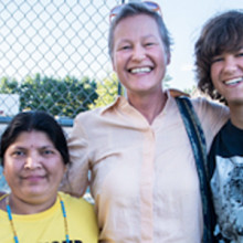 Linnea Duff (middle) and her son Peter (right), volunteering at an event in 2013. Peter volunteers teaching English as a second language to political refugees