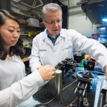 Guillermo "Gary" Tearney, MD, PhD, (center and shown in his lab in 2018) is leading the new Mass General Brigham Center for COVID Innovation with Dave Walt, PhD, of Brigham and Women's Hospital.