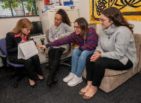 From the left, Dr. Valera and three of her students – Olivia Scott, Nathalia Quiroz Molinares and Annie-Lori Joseph – in her office at the Martinos Center.